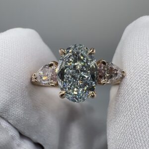 Blue Hour Diamond Ring: 1.57 carat Fancy Light Blue oval diamond between two Light Pink pear diamonds in 18K rose gold