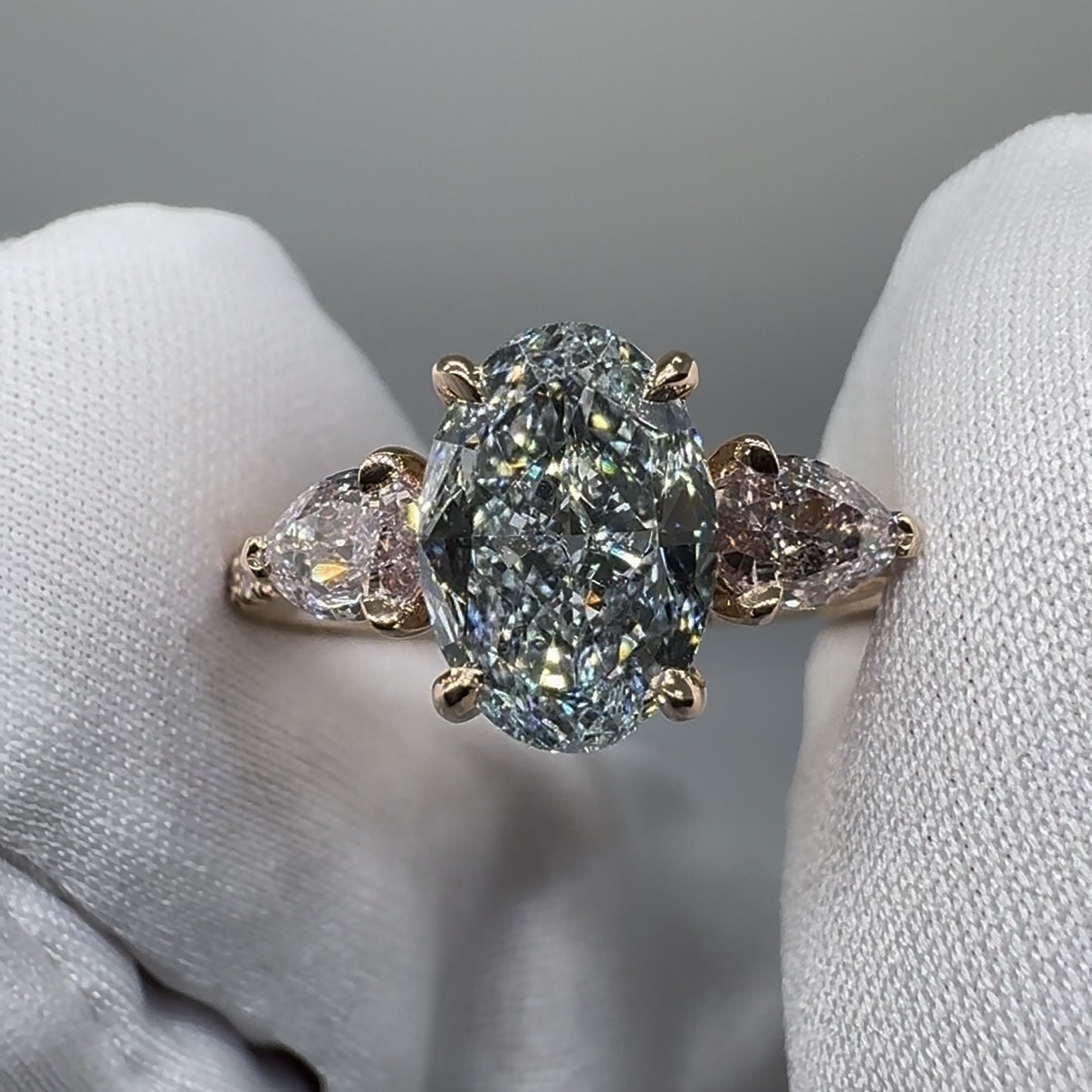 Blue Hour Diamond Ring: 1.57 carat Fancy Light Blue oval diamond between two Light Pink pear diamonds in 18K rose gold
